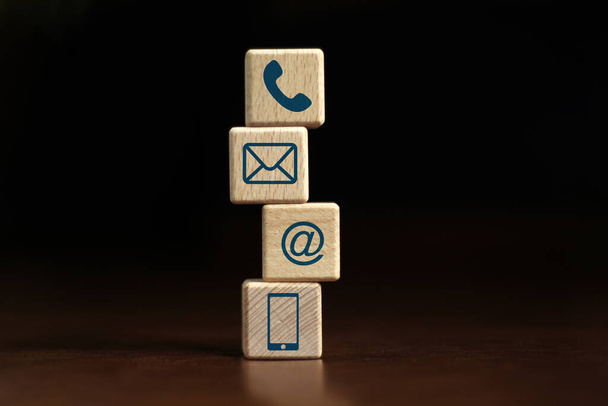 Wooden Blocks, Phones, Cube Symbols, Email, Address and Mobile Phones. Contact us website page or email marketing ideas. on a dark background. - 写真・画像