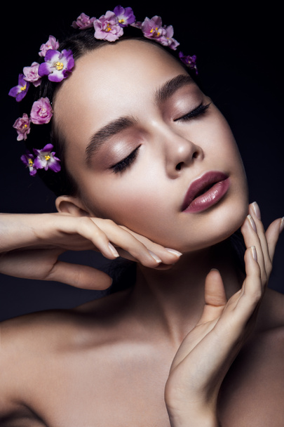 Beautiful girl with violet flowers. - Foto, Imagen