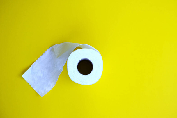 toilet paper roll over yellow background  - Fotografie, Obrázek
