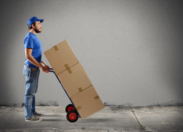 Courier with boxes on a cart - Photo, Image