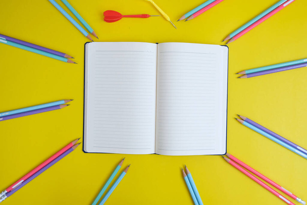 colorful background with stationary items and darts  - Photo, Image