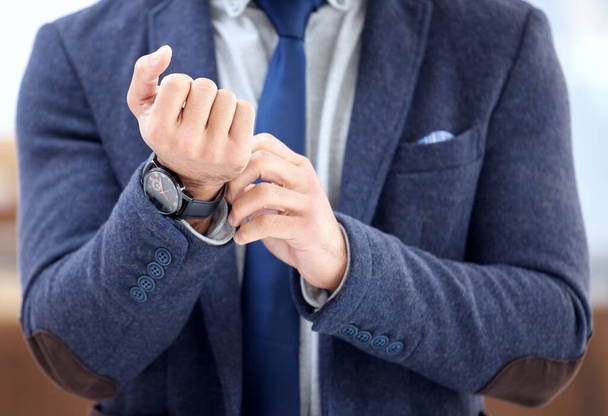 an unrecognizable businessman wearing a wristwatch. - Foto, Bild