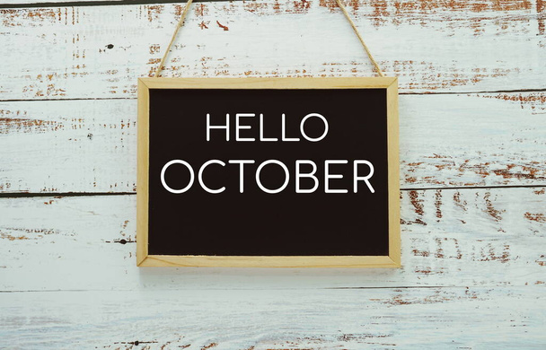Hello October typography text on blackboard hanging against on the wall background - Zdjęcie, obraz