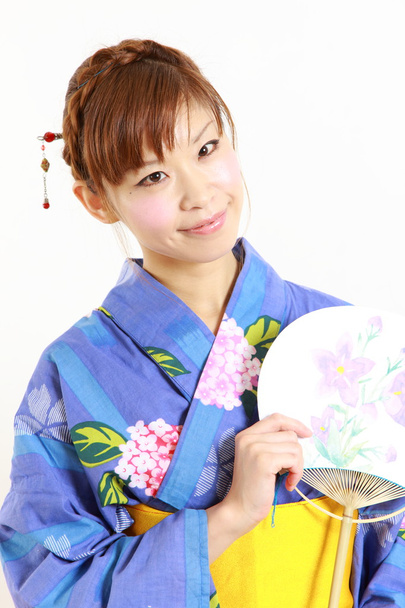 Young woman with paper Fan　 - Foto, imagen