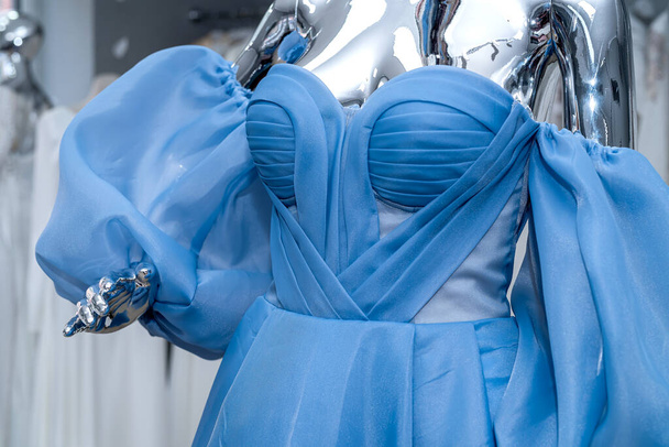 blue evening dress on mannequin for party bridesmaid wedding in bridal shop. fashion concept - Valokuva, kuva