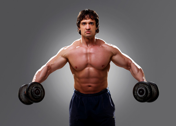 Bodybuilder lifting some weights, closeup - Фото, зображення