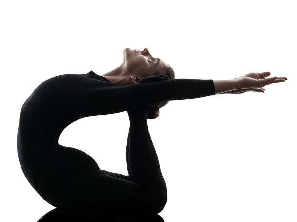 woman contortionist  exercising gymnastic yoga   silhouette - Foto, imagen