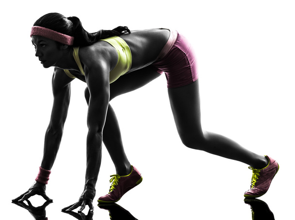 woman runner running on starting blocks silhouette - Foto, afbeelding