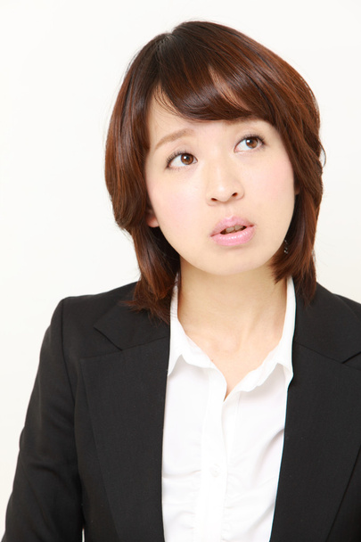 Japanese businesswoman thinks about something - Φωτογραφία, εικόνα