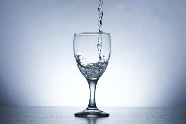 Photo of pouring water into SOUR GLASS - Foto, afbeelding