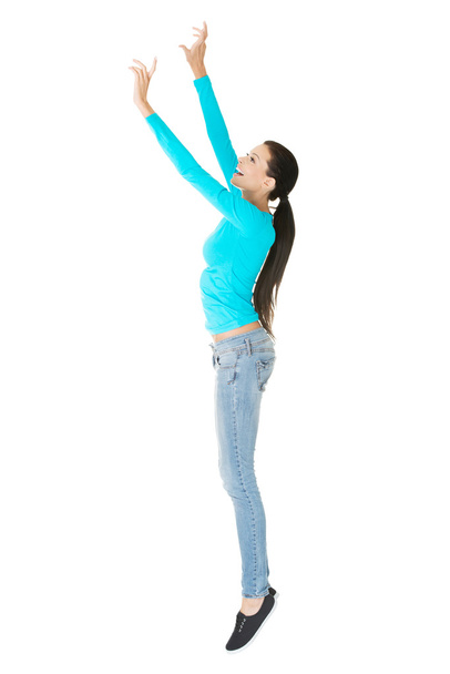Woman trying to reach high - Φωτογραφία, εικόνα