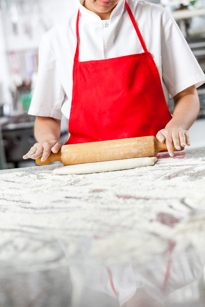 Chef Rolling Dough At Messy Counter - Foto, Imagen