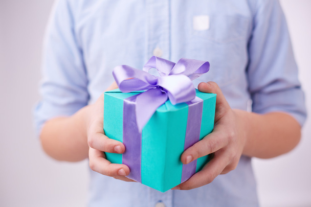 Boy holding package with ribbon - Photo, Image