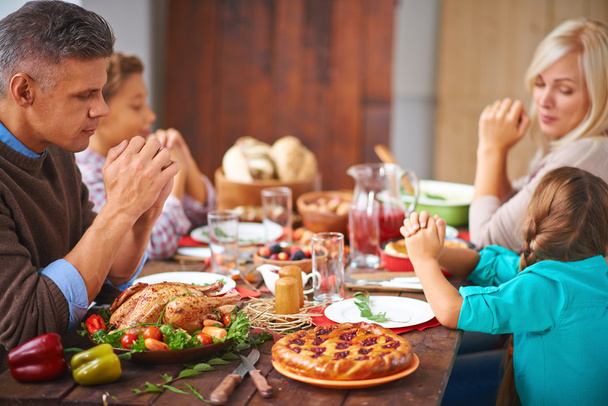 Family sitting at Thanksgiving festive table - Photo, Image