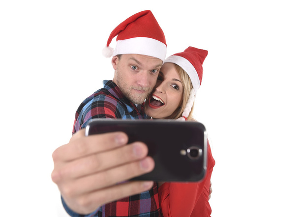 young romantic couple in love taking selfie mobile phone photo at Christmas - Photo, Image