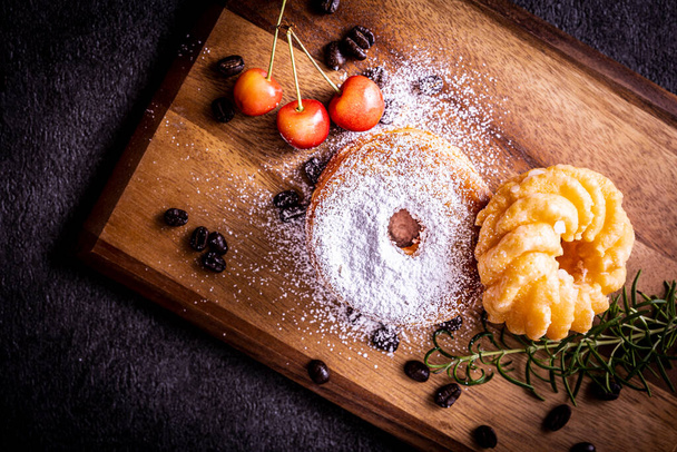 Two stylish and delicious donuts on the cutting board - 写真・画像