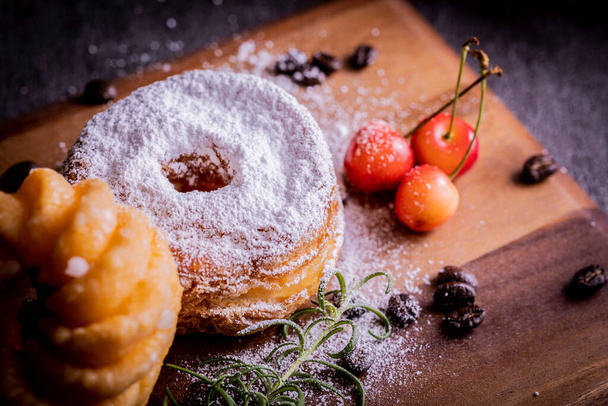 Two stylish and delicious donuts on the cutting board - Zdjęcie, obraz