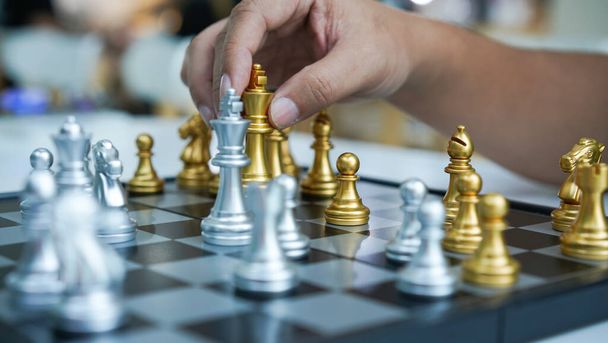 Chess is board game to improve thinking and strategy planning. Gold and silver chess on board in room for playing. - Fotó, kép