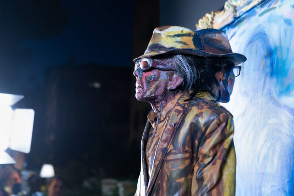 Rehovot, israel-July 7, 2022. Exhibition of living statues on the crowded Rehovot street at night. The artist portrays the good and evil in a person - Photo, Image