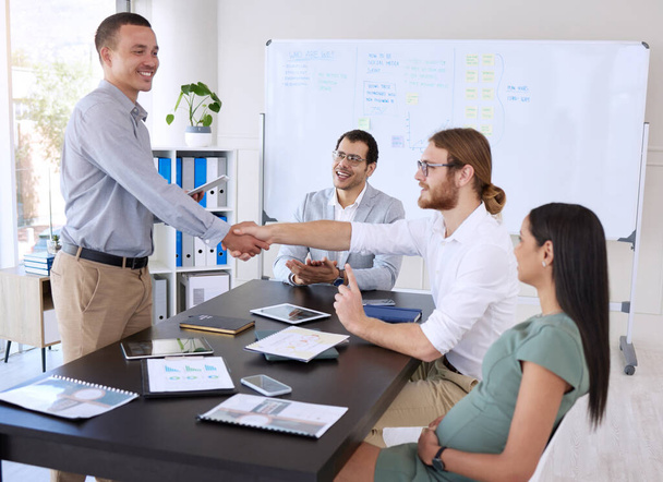 a diverse group of businesspeople shaking hands during a meeting in the office. - Photo, image