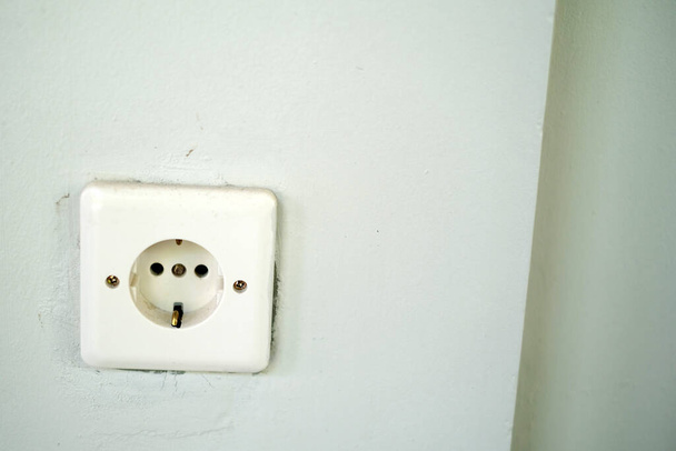 Electrical socket isolated on wall with copyspace - Fotoğraf, Görsel