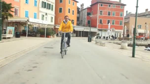 Man cycling on road - Filmati, video