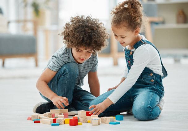 two siblings playing with building blocks. - Fotó, kép