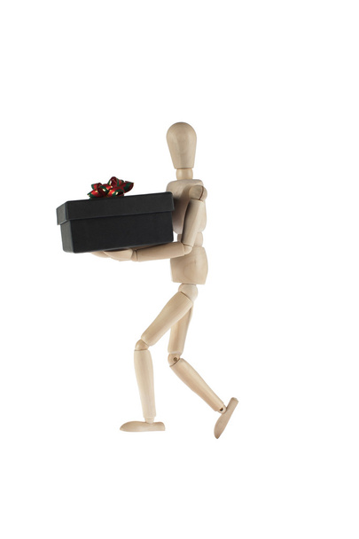 wooden male model carries gift box - Φωτογραφία, εικόνα