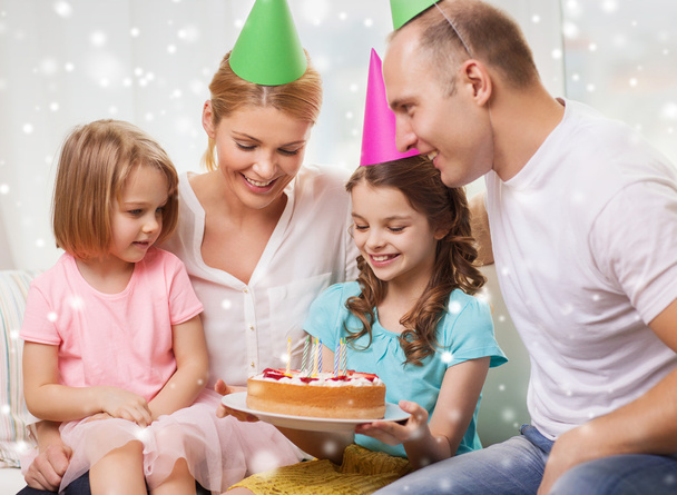 happy family with two kids in party hats at home - Photo, image