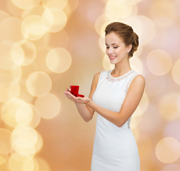 smiling woman holding red gift box with ring - Fotoğraf, Görsel