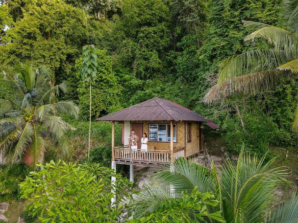 Railay Beach Krabi Tayland, ormanda sırt çantalı bambu kulübeleri olan tropikal bir plaj. Okyanus kıyısındaki ormanda güzel bir bambu kulübesi. - Fotoğraf, Görsel