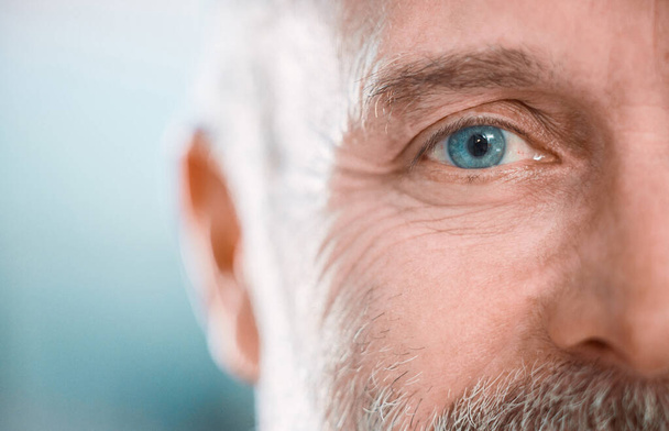 an unrecognisable man looking into the camera during a day in the office. - 写真・画像
