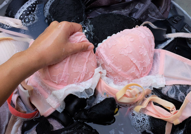Washing bras in the basin. Washing clothes by hand. - Foto, immagini