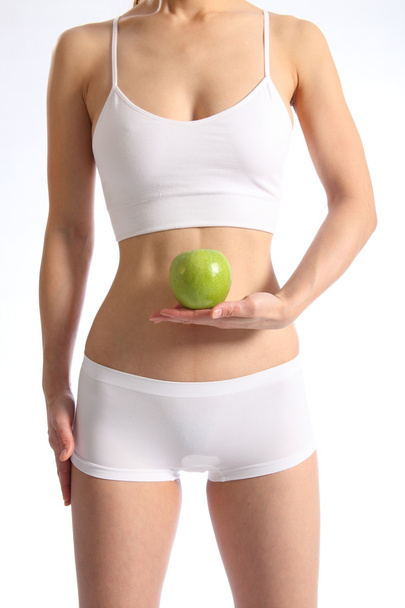 Healthy female torso with apple - Foto, afbeelding