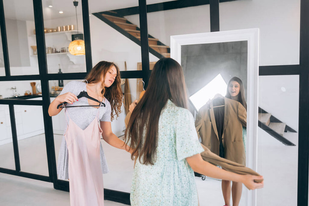 Image of pretty females trying on dress at home - Fotoğraf, Görsel