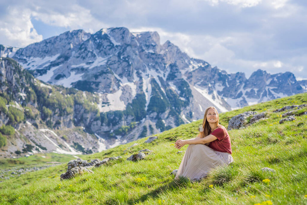 Woman tourist in Mountain lake landscape on Durmitor mountain in Montenegro beautiful Durmitor National park with lake glacier and reflecting mountain. - 写真・画像