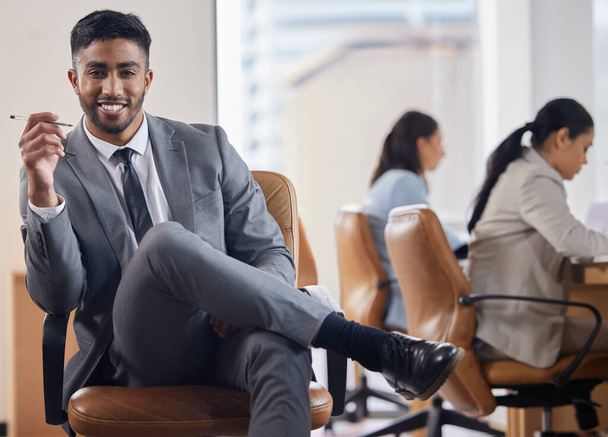 a handsome young businessman sitting in an office. - Photo, image