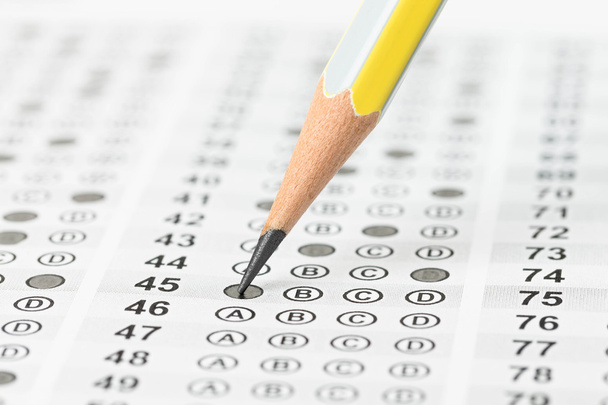 Filled answer sheet focus on pencil - Photo, Image