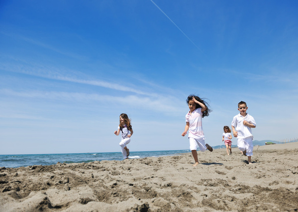 Happy child group playing on beach - Fotó, kép
