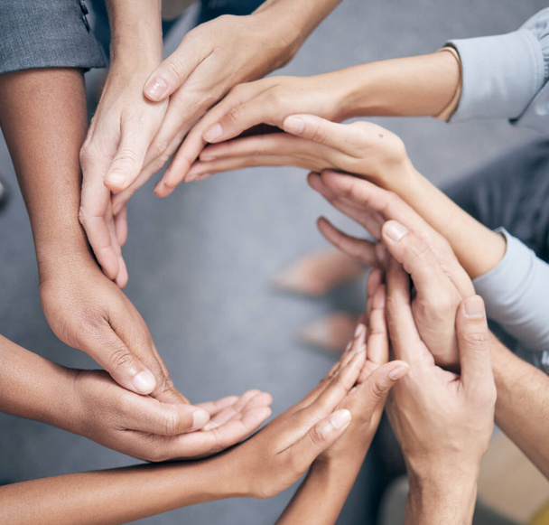 Shot shot of a group of unidentifiable businesspeople joining their hands together in a unity. - Fotografie, Obrázek