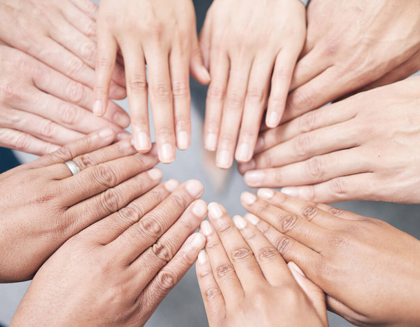 Shot shot of a group of unidentifiable businesspeople joining their hands together in a unity. - Foto, immagini