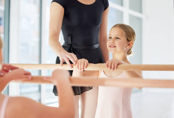 a little girl practicing ballet with her teacher in a dance studio. - Fotoğraf, Görsel