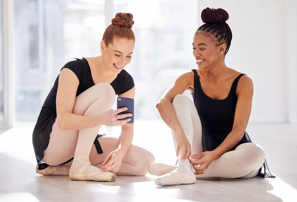 a ballet dancer showing her friend her smartphone. - Foto, Imagem