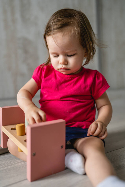 egy gyermek kis kaukázusi lány kis csecsemő játszik oktatási játékok otthon gyermekkorban és felnő korai fejlesztési koncepció másolja tér elölnézet - Fotó, kép