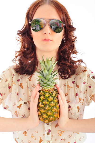 Closeup portrait of woman in sunglasses holding pineapple in her - Foto, Imagem