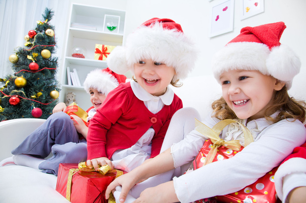 Children in Christmas hat with presents - Fotó, kép