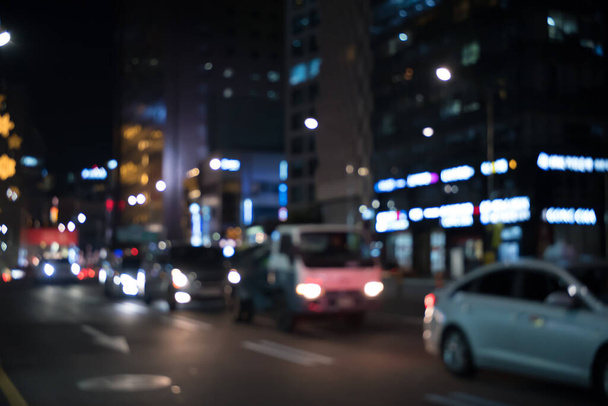 Abstract background, colorful night light bokeh of advertising signs and street car in the city - 写真・画像
