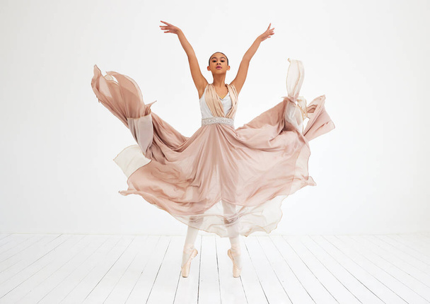 Teljes hossz felvétel egy vonzó fiatal női balerináról, aki a táncstúdiójában gyakorol.. - Fotó, kép