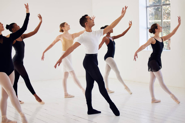 a group of ballet dancers practicing a routine in a dance studio. - Fotografie, Obrázek