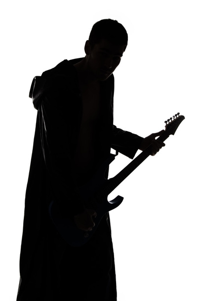 Portrait of young mans silhouette with the guitar - Photo, Image